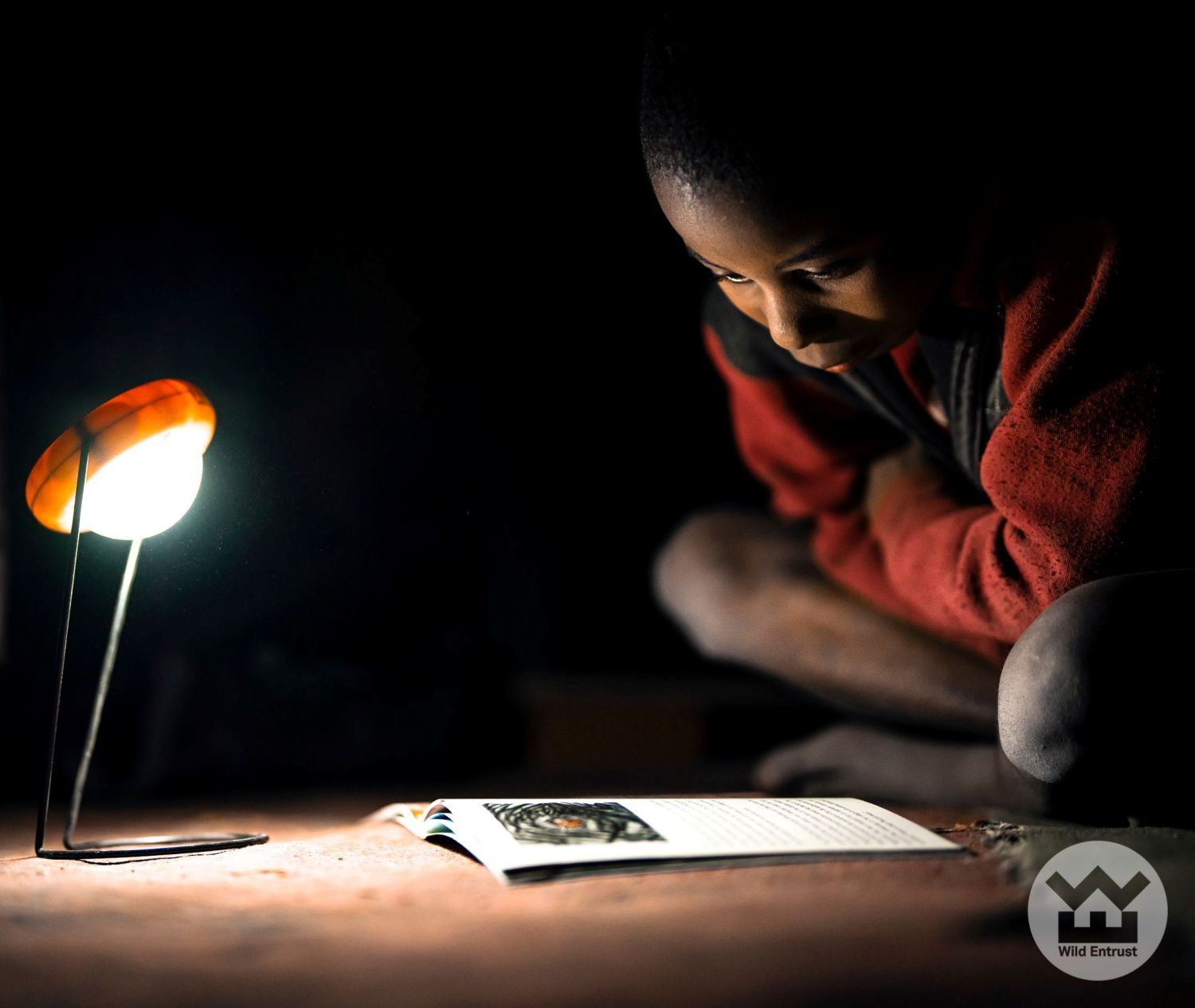 A student studying under a solar-powered light, part of the Village Lights Project in Botswana. Credit: Cole Franklin.